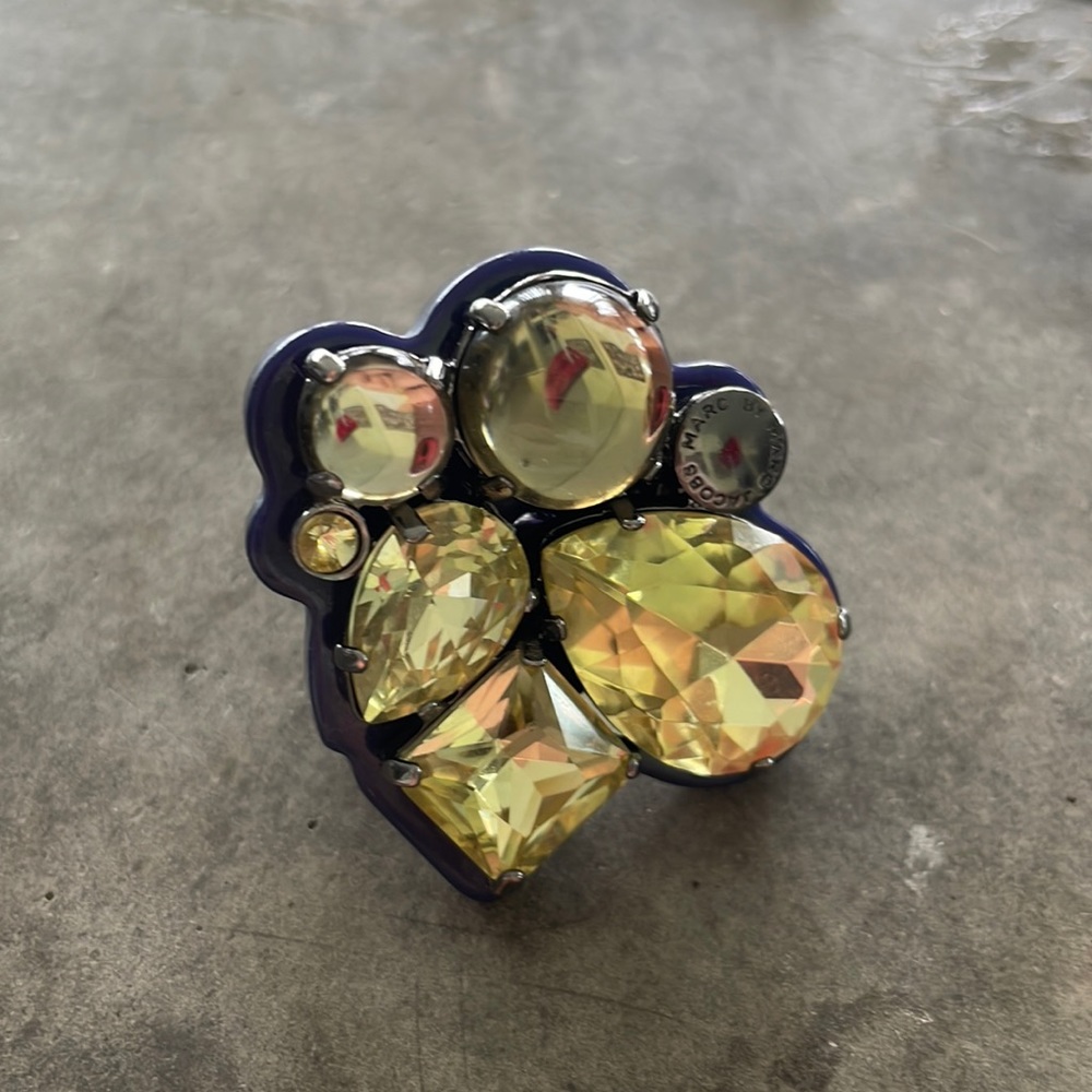 Very cool chucky ring navy plastic resin and yellow stones . Statement piece .